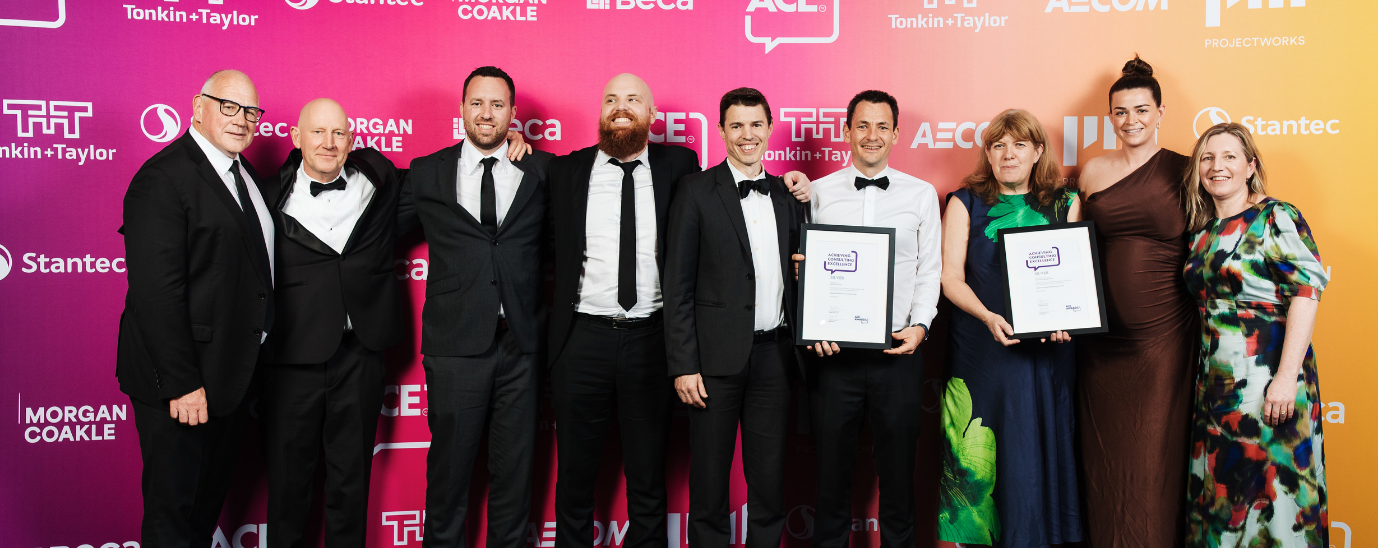 A group of nine people posing with an award at the ACE Awards 2025