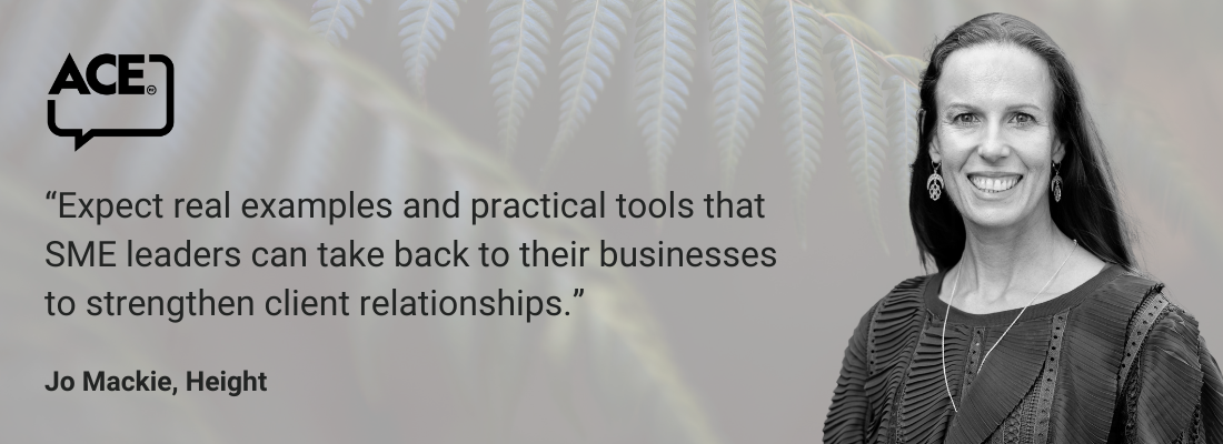 White female, long dark hair, earrings, smiling.