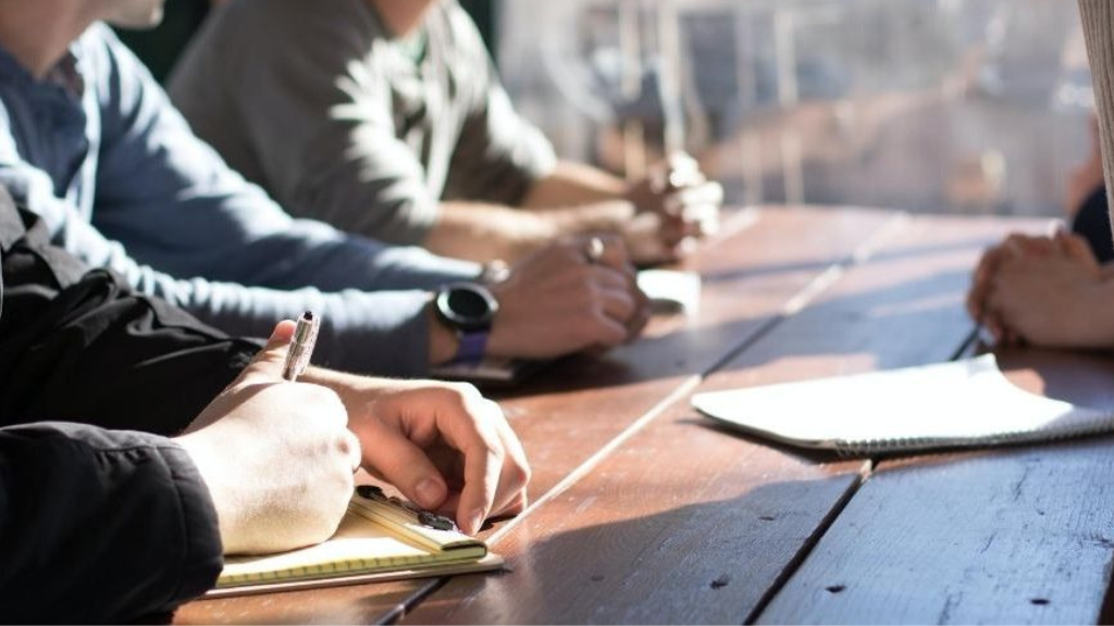 A picture of a group of people at a meeting table.
