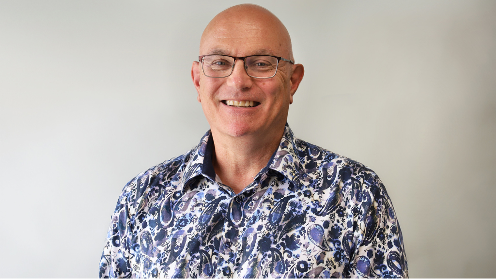 Philip Aldridge - a man in a blue shirt smiling at the camera