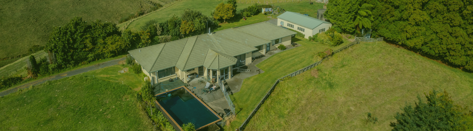 A picture of a large rural house on a hill.
