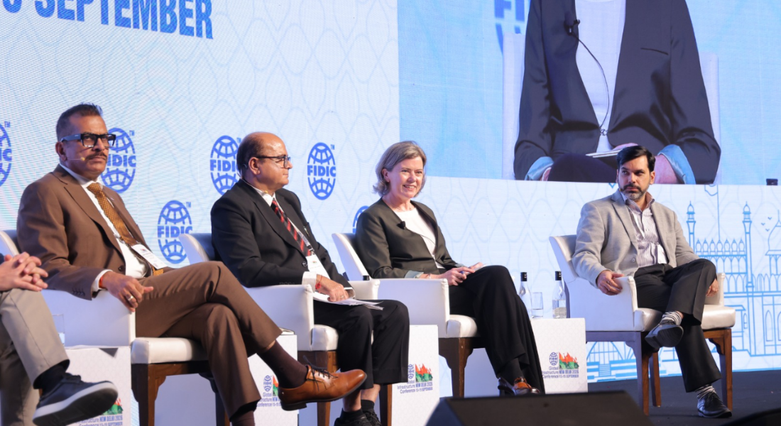 Penny Kneebone sits on a panel of four people in India.